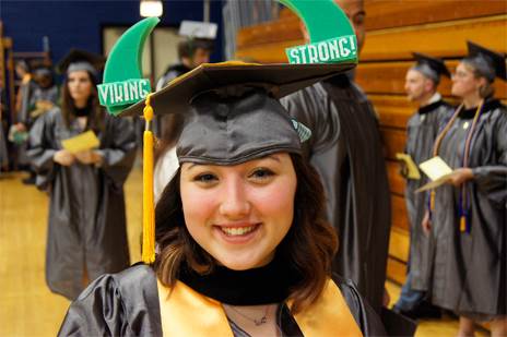 Woman in graduation cap and gown at graduation