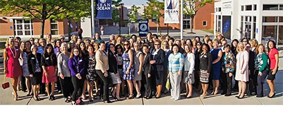 Large group of OCC alumni in a group photo on campus