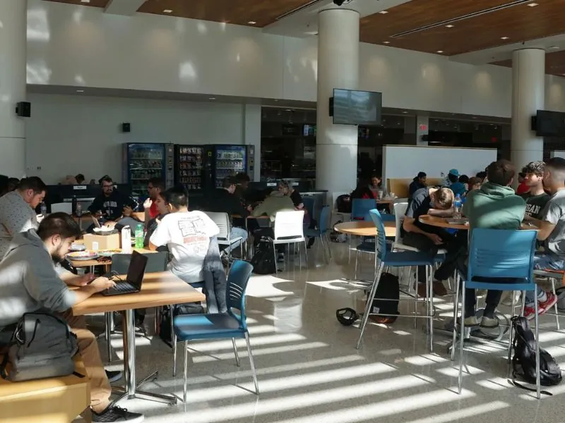 Students sitting at tables inside the cafeteria