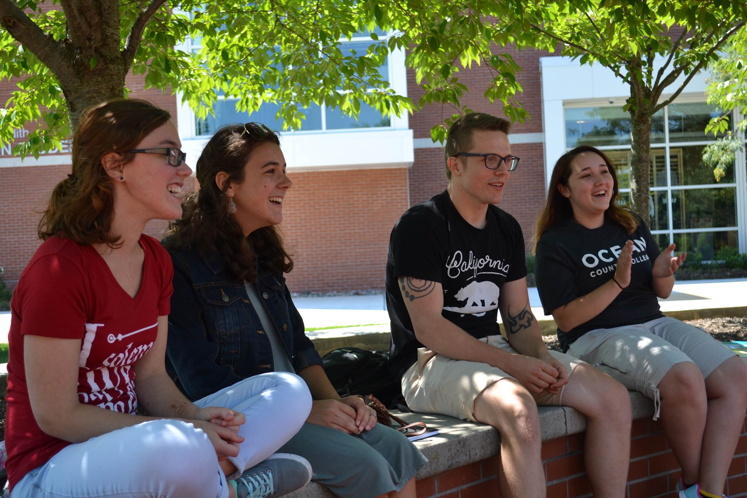 Group of students sitting and talking outside on campus