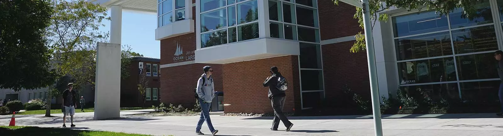 Students walking by a building on campus