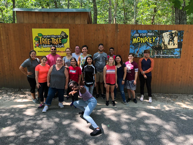 Students standing in front of brown fence at the Zoo