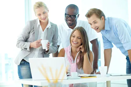 group of young professionals in front of a computer