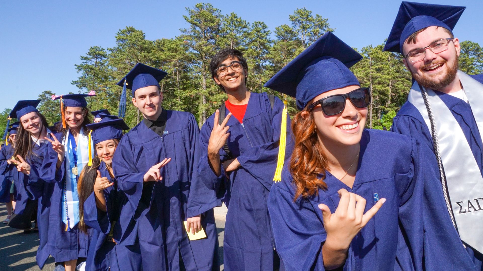 Students posing at the camera during commencement