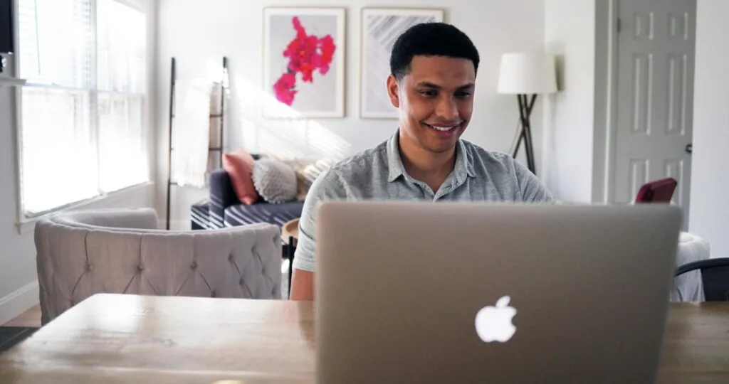 man working from a laptop in a home office