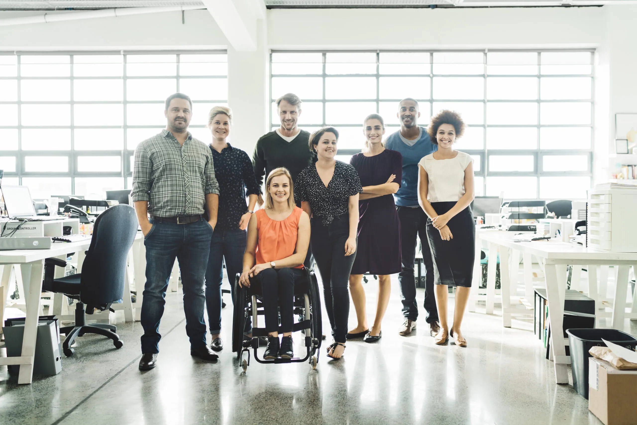 Diverse business people smiling in creative office.