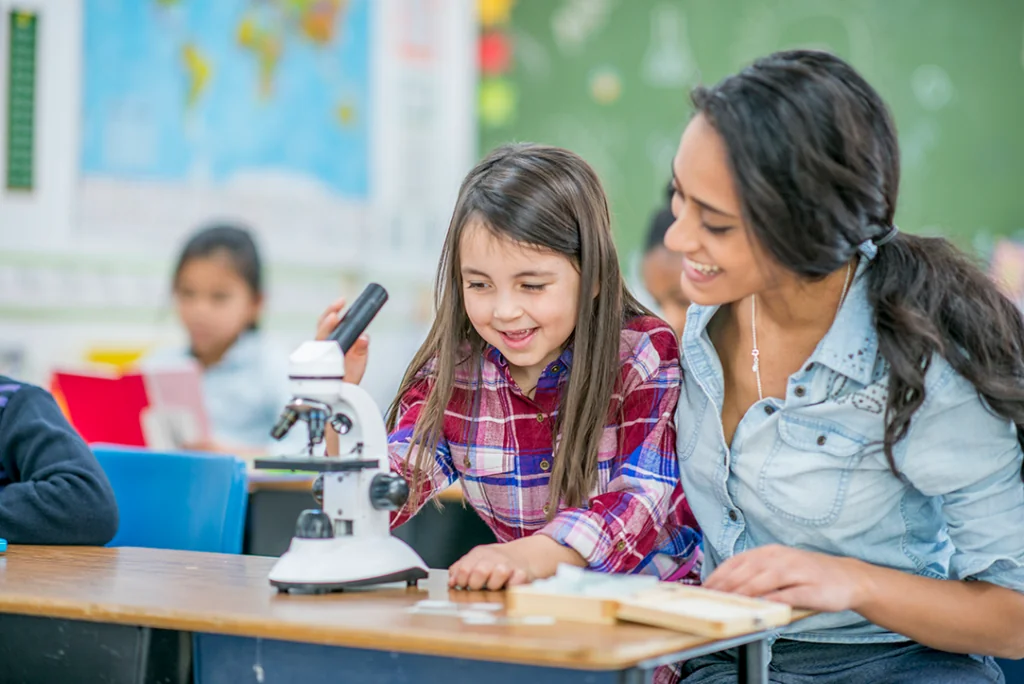 Teacher helping young student