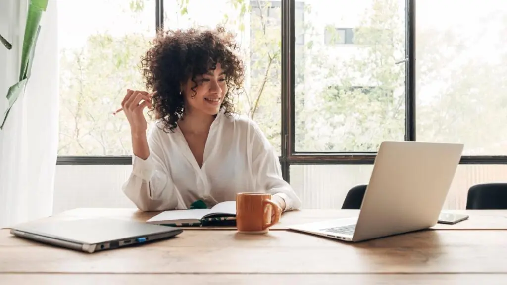 Woman sitting at table doing online work