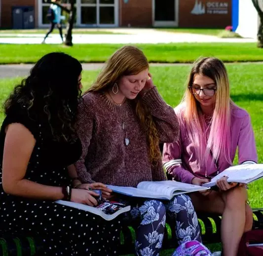 students reading on campus