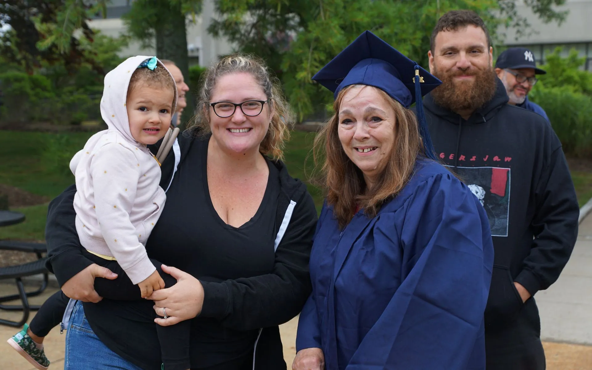 Family posing together at graduation ceremony