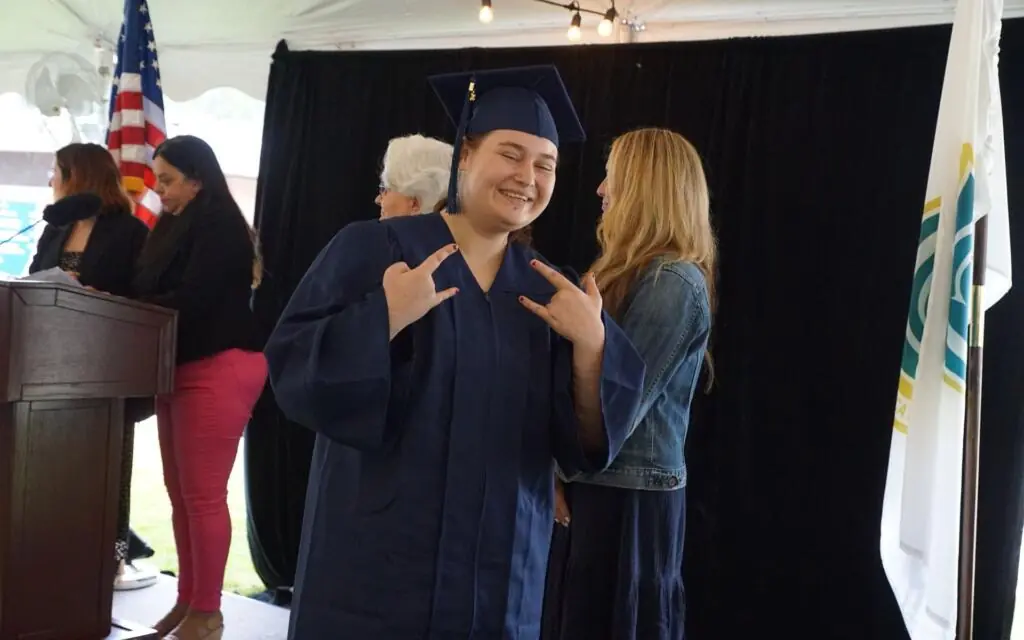 Smiling graduate in cap and gown