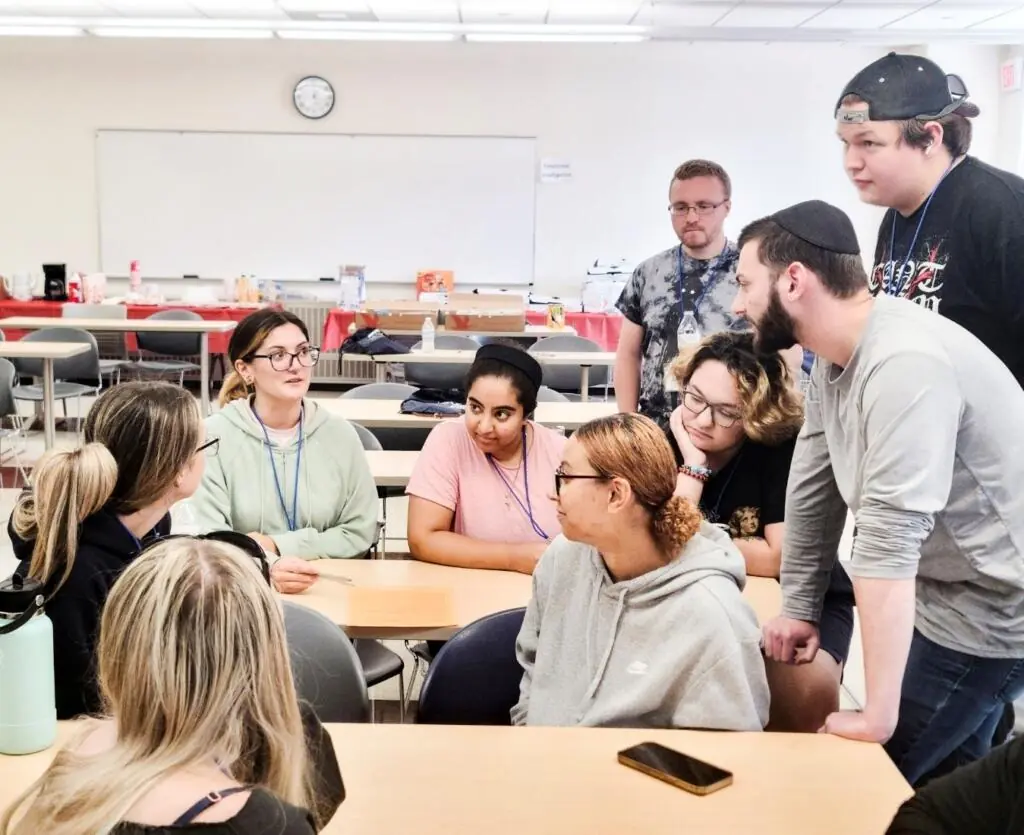 Group of diverse students sitting in a group discussion in a classroom