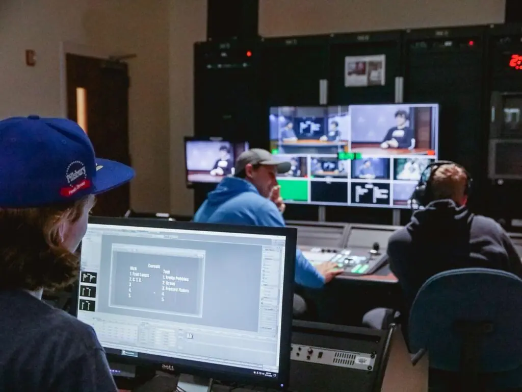 students in a studio behind computer screens