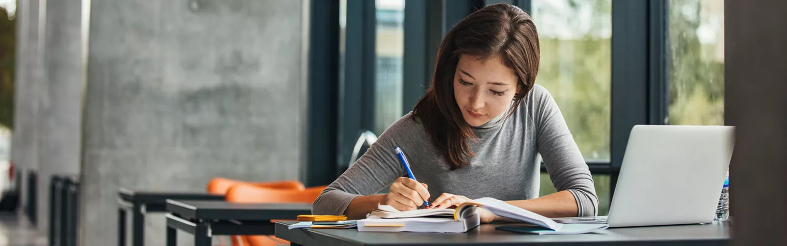 Woman doing homework at a table.