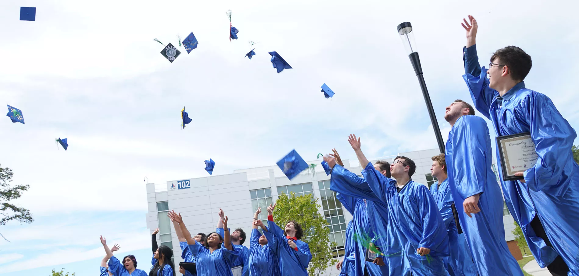 Graduates throwing their caps at graduation