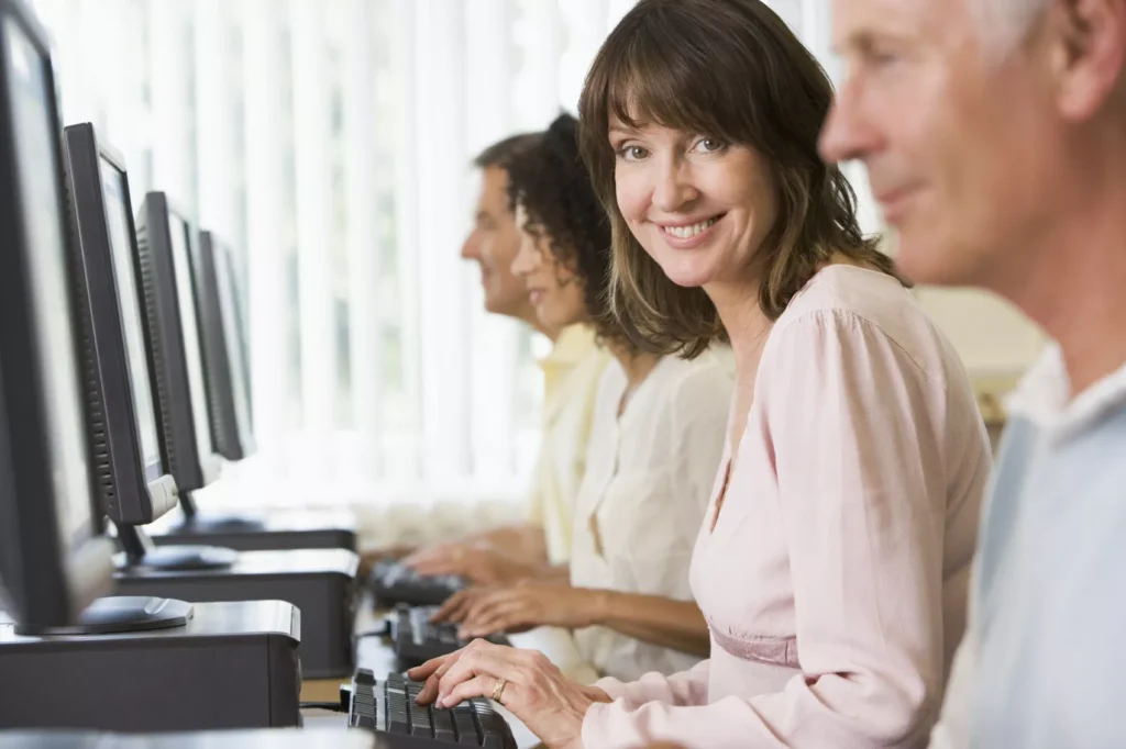 Woman in a computer lab smiling at the camera