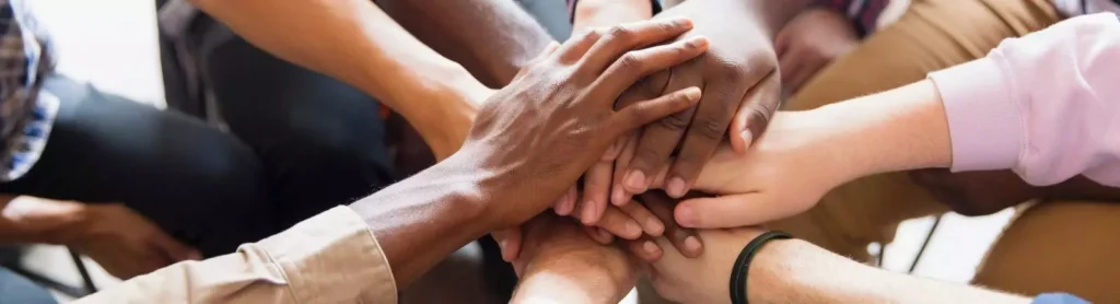 A group of students stacking their hands