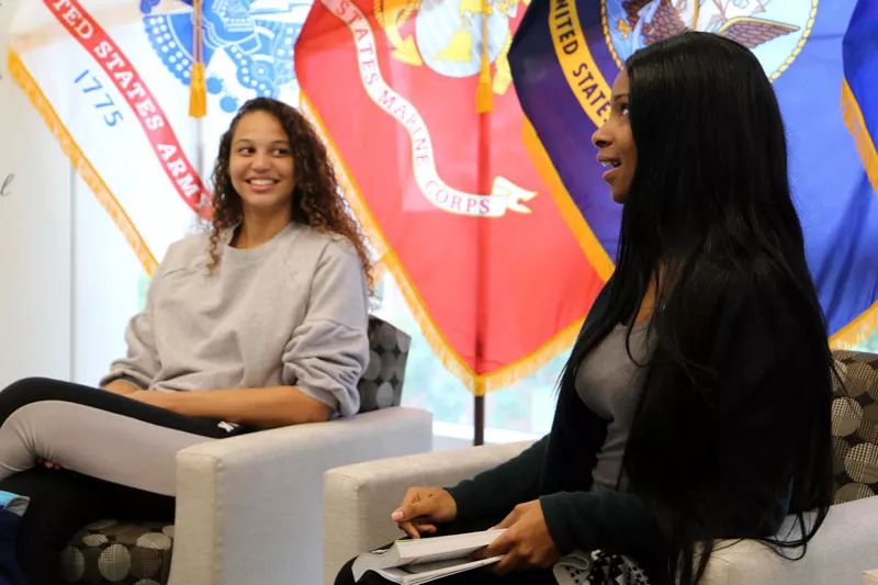 Two female students talking in the Veterans Lounge