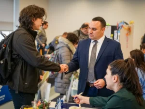 student shaking professor's hand