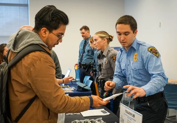 student and police officer talking