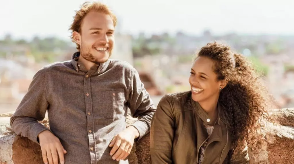 A man and a woman laughing and smiling