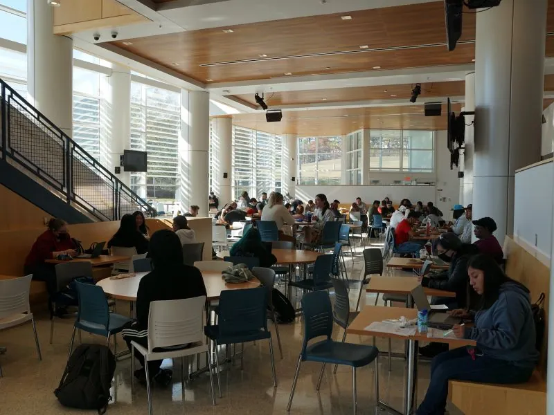 Students sitting around tables inside the cafeteria