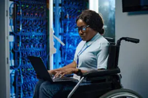 Woman in wheelchair working on a laptop.