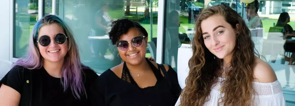 three students smiling