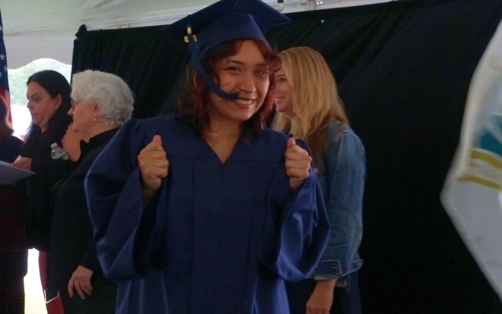 Graduate giving a thumbs up