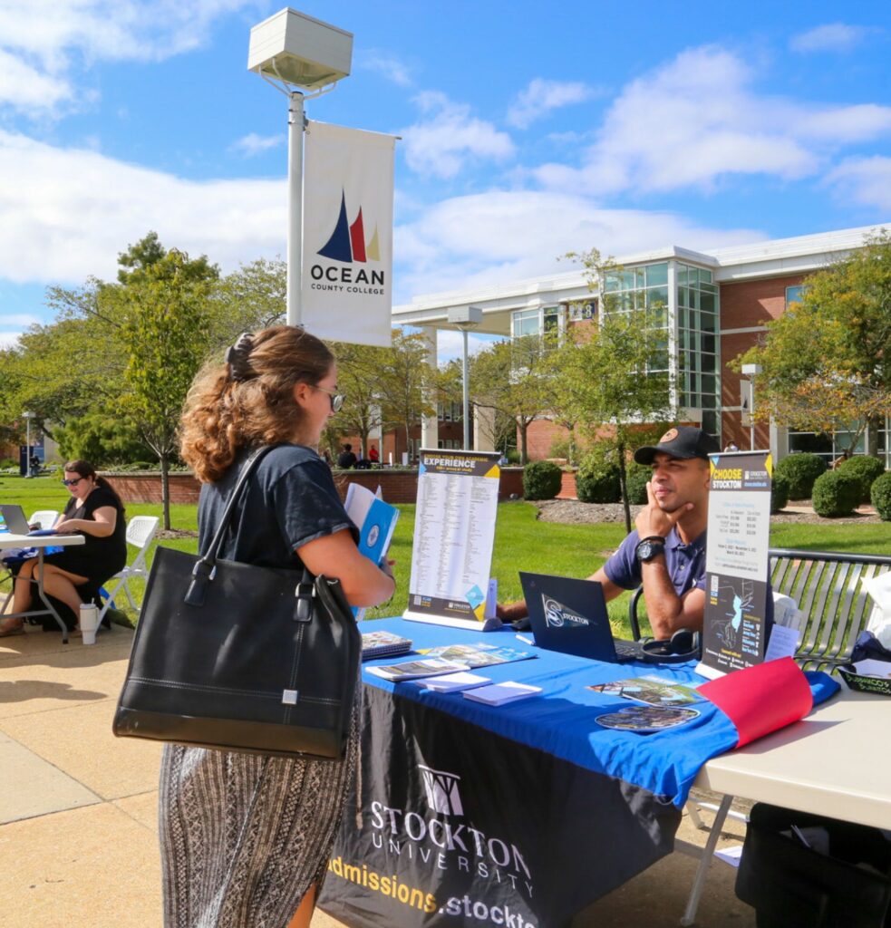 Student talking to Stockton representative at OCC Transfer Fair