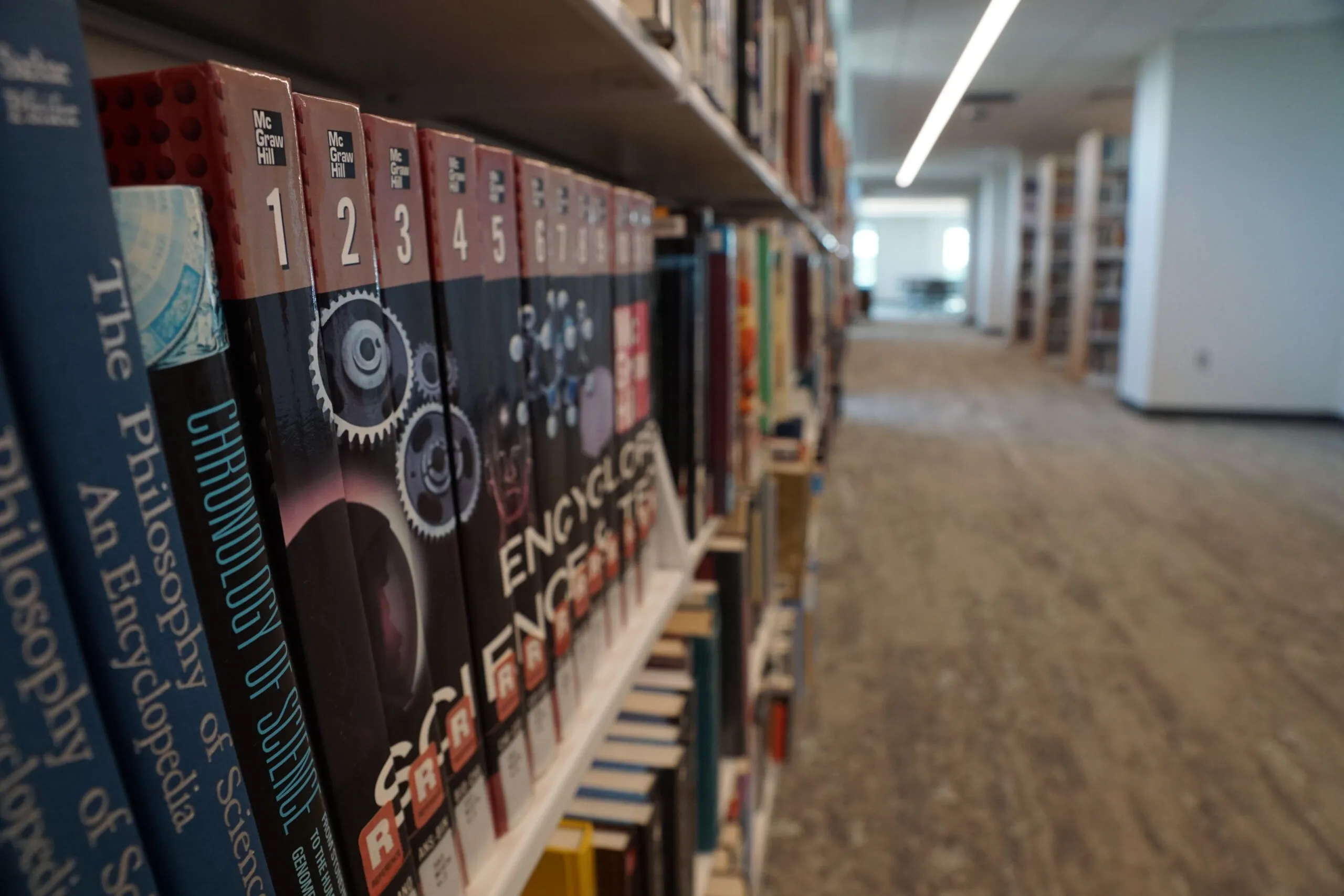 Close up of reference books on a shelf in the library