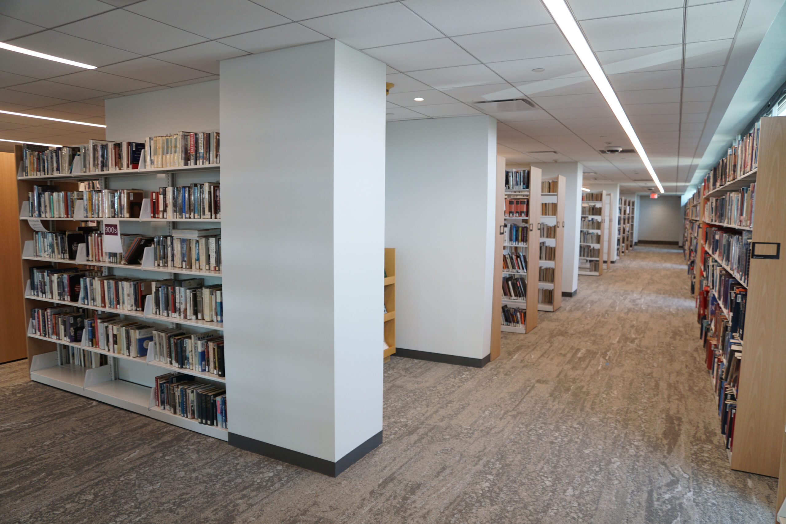 A row of bookshelves filled with books in the new library